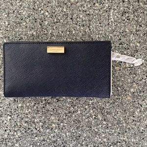 Brand new never used Kate Spade button wallet.